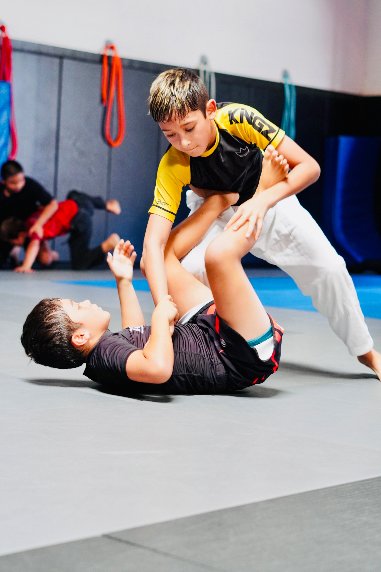 Kids jiu-jitsu athletes practicing live guard passing at GDA in San Diego