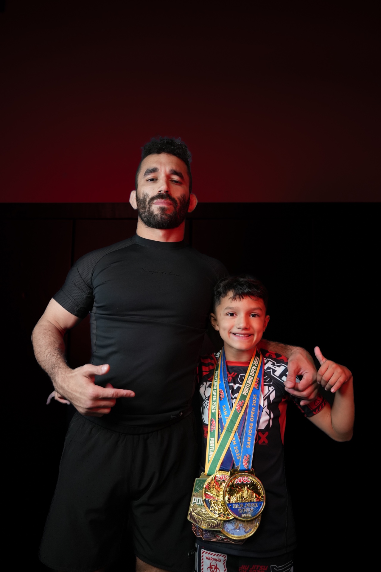 Professor Mike Perez with a GDA athlete holding competition medals